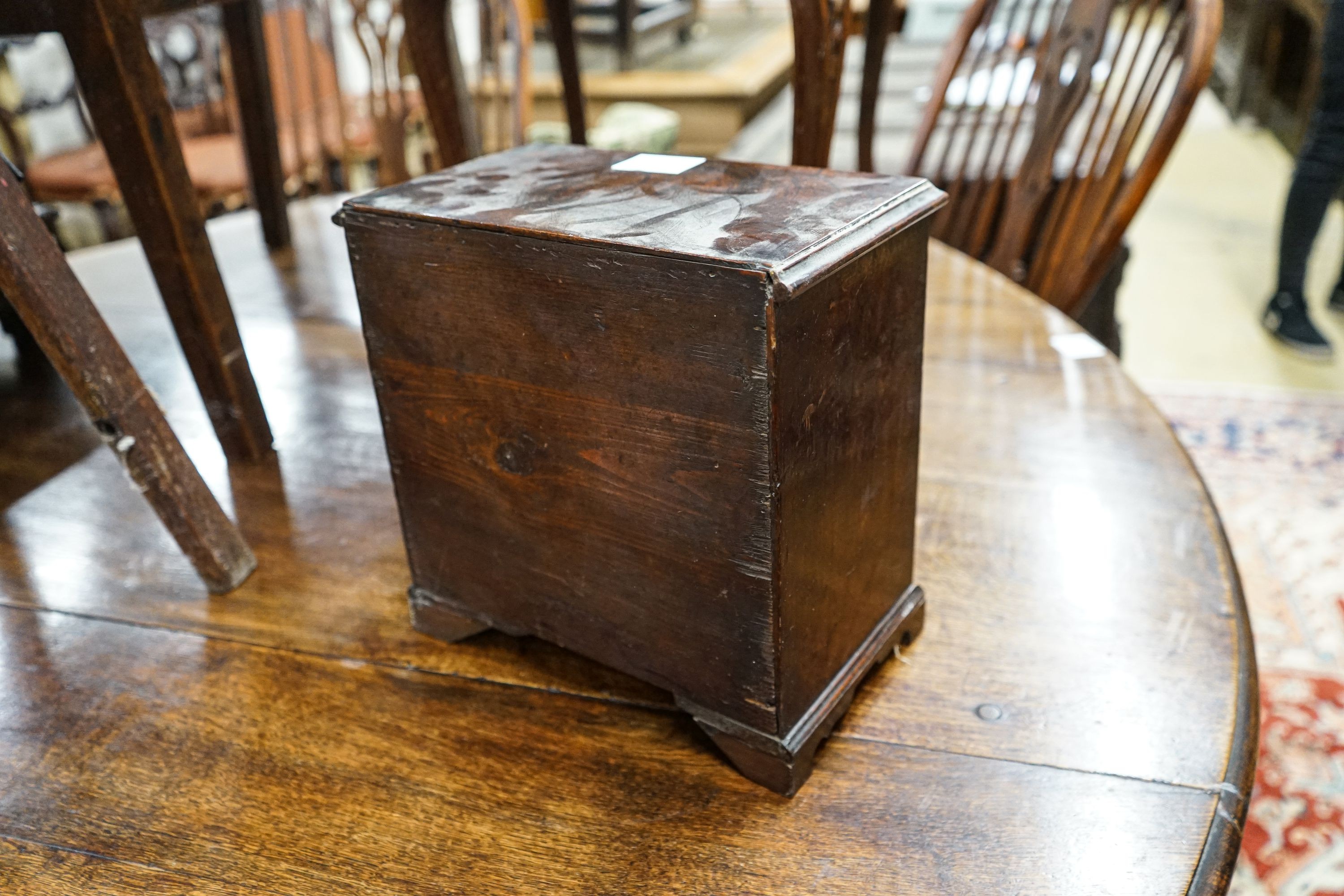 An antique mahogany miniature chest of drawers, width 27cm, depth 16cm, height 27cm